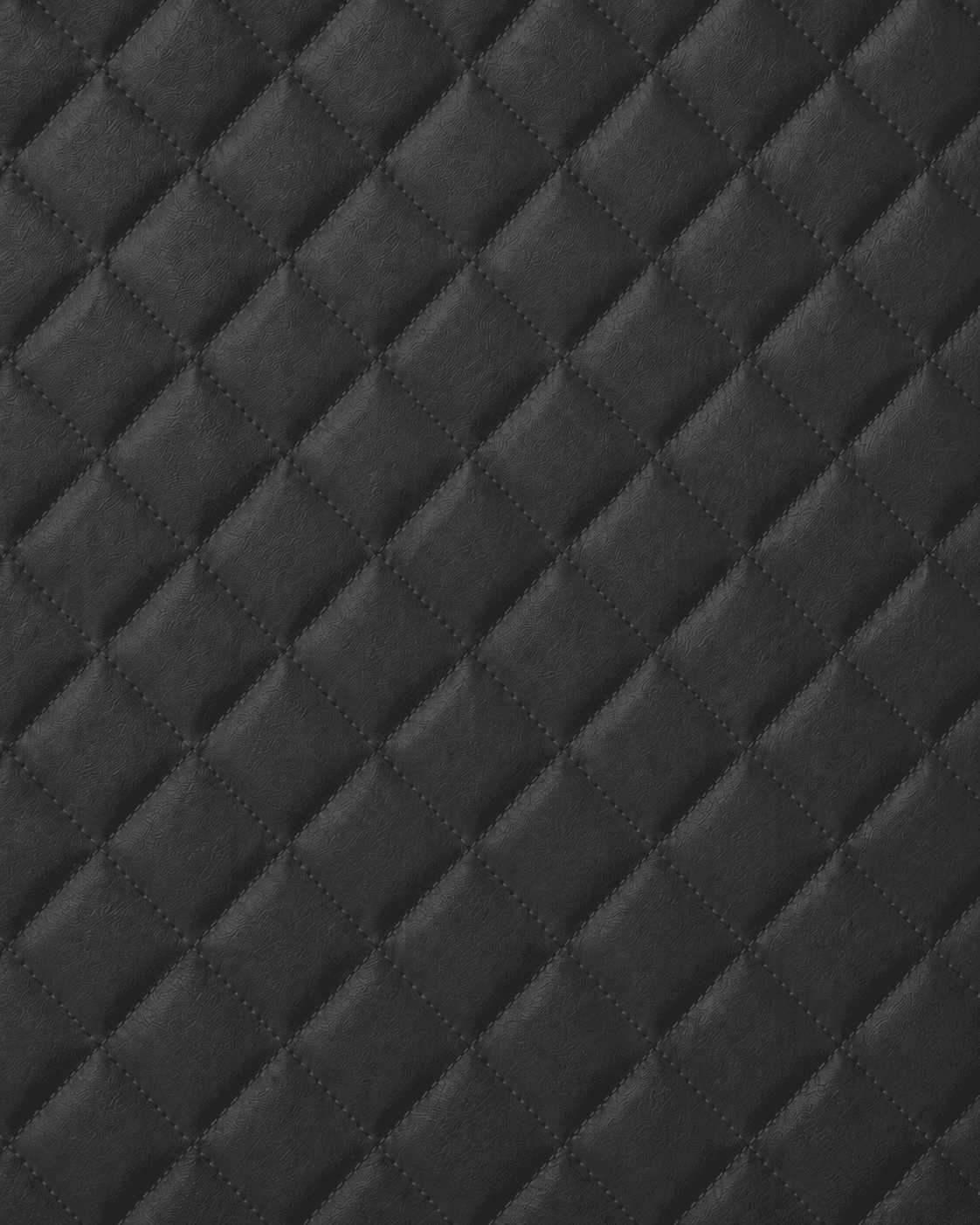 Close-up of rich charcoal dark gray quilted leather interior lining with diamond stitching