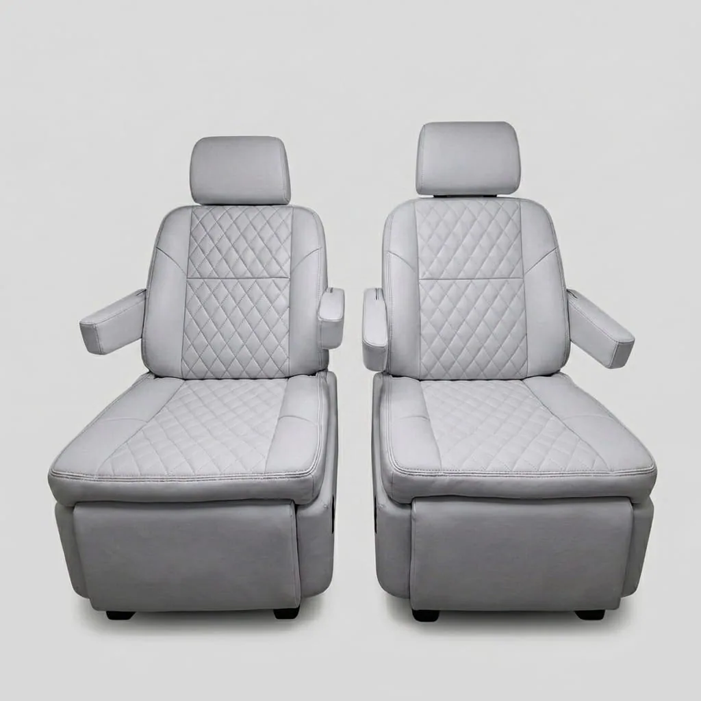 Premium light gray quilted leather captain's chairs reclined with footrests extended, showing electric reclining and footrest adjustment