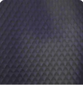 Close-up of rich charcoal dark gray quilted leather interior lining with diamond stitching