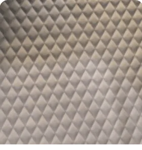 Close-up of soft light gray quilted leather interior lining with diamond stitching